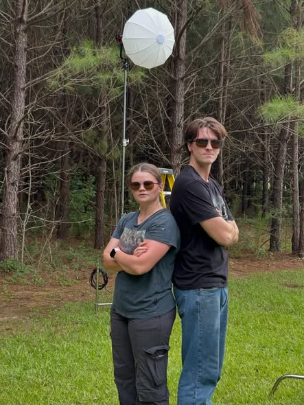 Jesse and a crew member beside production lighting